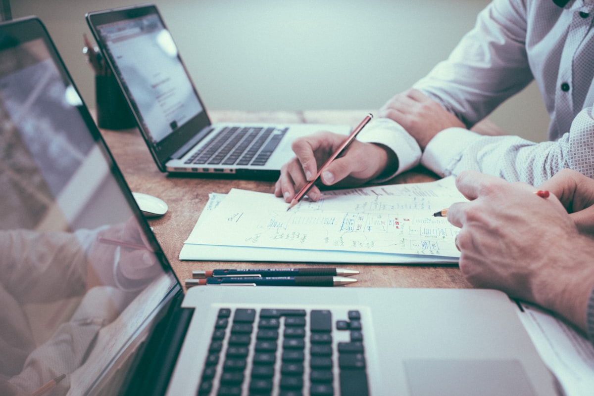 Two professionals reviewing corporate documents at a desk